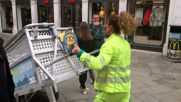 Venice garbage collectors walk the streets every morning (except Sundays).