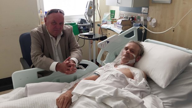 Paul Roberts visits his brother John in the Royal Melbourne Hospital on Tuesday.
