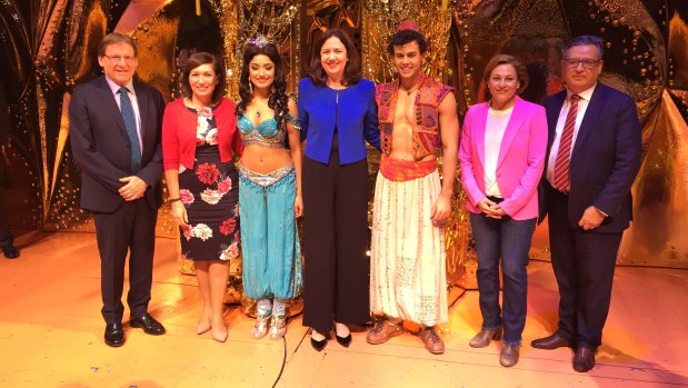 The announcement was held on the Aladdin stage. Left to right: Queensland Performing Arts Trust chairman Professor Peter Coaldrake, Arts Minister Leeanne Enoch, Aladdin's Princess Jasmine (Shubshri Kandiah), Premier Annastacia Palaszczuk, Aladdin (Ainsley Melham), Deputy Premier Jackie Trad, QPAC chief executive John Kotzas.