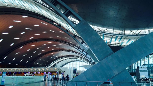 The striking, curving architecture of Hamad International Airport is designed to represent ocean waves and sand dunes.