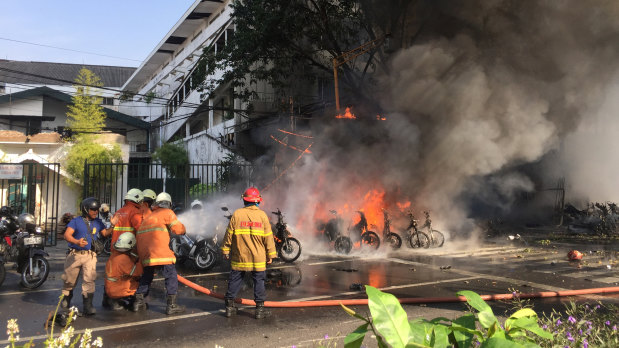 Firefighters try to extinguish a blaze following a blast at the Pentecost Church Central Surabaya (GPPS) in Surabaya.