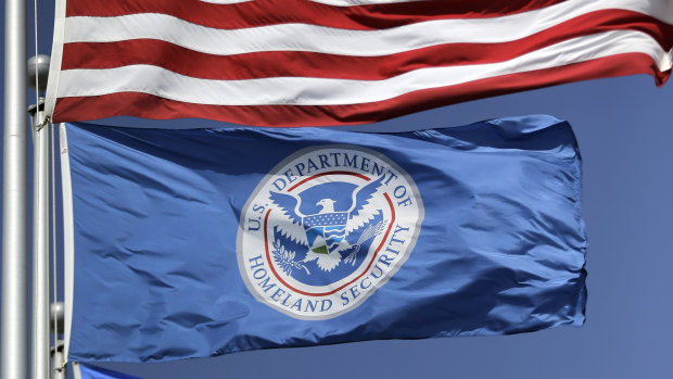 The US and US Department of Homeland Security flags fly in Karnes City, Texas.  