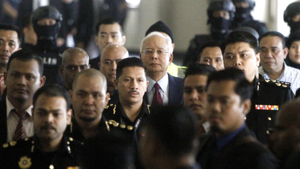 Najib Razak walks into a courtroom in Kuala Lumpur, Malaysia where he was charged with corruption offences.
