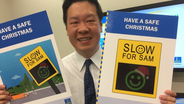 Brisbane councillor Stephen Huang with the new Santa SAM - traffic signs with Santa faces to begin on December 1.