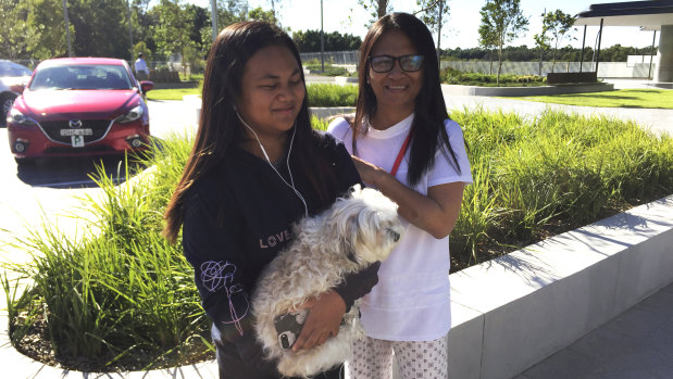 Lanie Devera, with her daughter Avril, 12, and dog Coco, outside Opal Tower in Olympic Park.