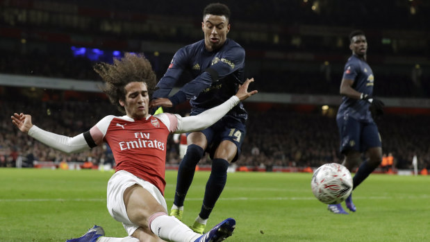 Arsenal's Matteo Guendouzi duels with Manchested United's Jesse Lingard. 