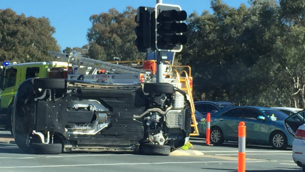 A car rests on its side at the intersection of Hindmarsh Drive and Yamba Drive on Sunday afternoon.