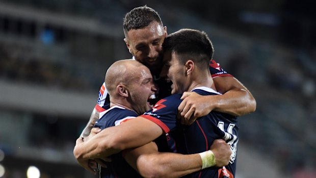 Winners are grinners: Quade Cooper celebrates with Billy Meakes and Jack Maddocks.