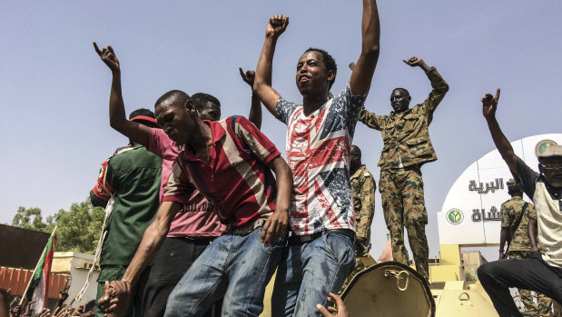 Sudanese celebrate after officials said the military had forced longtime autocratic President Omar al-Bashir to step down after 30 years in power in Khartoum, Sudan.