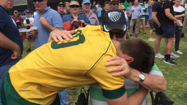 Harrison and his grandfather hug it out after a Junior Wallabies match. 