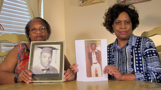 Mylinda Byrd Washington, 66, right, and Louvon Byrd Harris, 61, hold up photographs of their brother James Byrd jnr. in Houston this month.