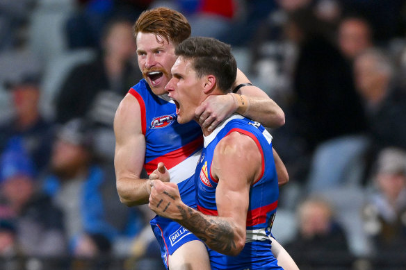 Oskar Baker and Rory Lobb of the Bulldogs celebrate a goal.