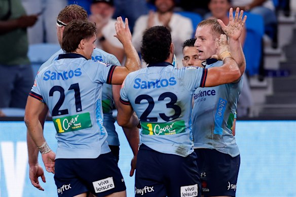Max Jorgensen of the Waratahs celebrates a try during the round two Super Rugby match.