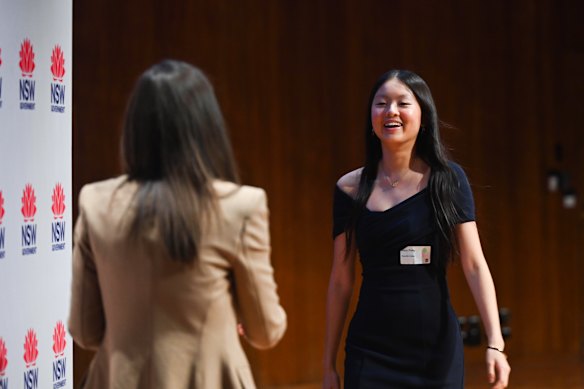 Stacy Zhang receives her awards for topping chemistry and biology from acting education minister Courtney Houssos. 