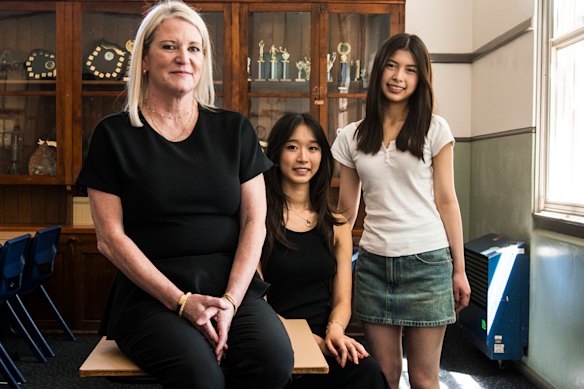 North Sydney Girls High deputy principal and English teacher Jane Stocks with top students Emily Phi (centre) and Valery Lin, who co-topped the state in advanced English.