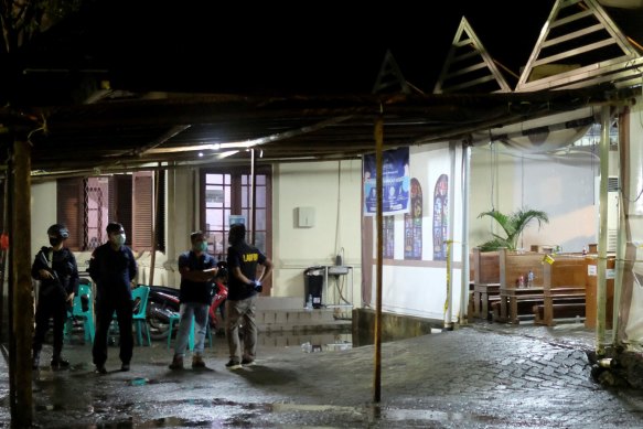 Members of Indonesian anti-terror squad stand in front of the church hit by a bombing in Makassar, South Sulawesi, Indonesia, March 28, 2021. 
