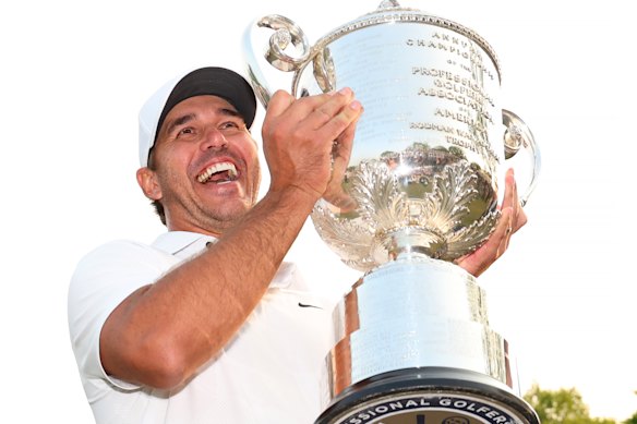 Brooks Koepka holds up the Wanamaker Trophy after winning the 2023 PGA Championship.