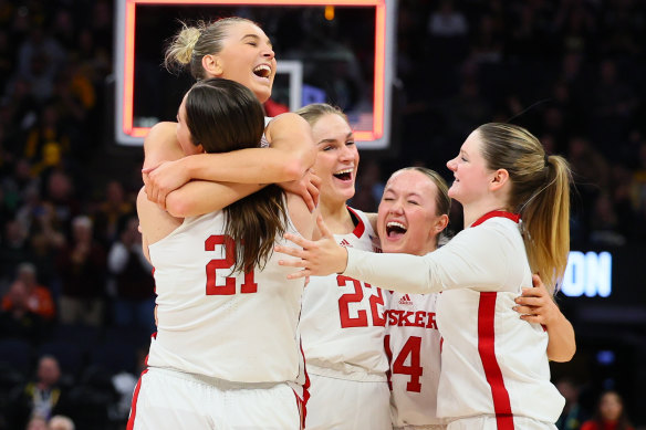 Nebraska’s Jaz Shelley hugs her teammates after a win over Maryland.