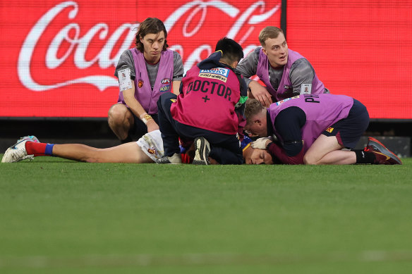 Hugh McCluggage of the Lions is seen to after a collision during the round 13 match against the Hawks at the Melbourne Cricket Ground on June 10.