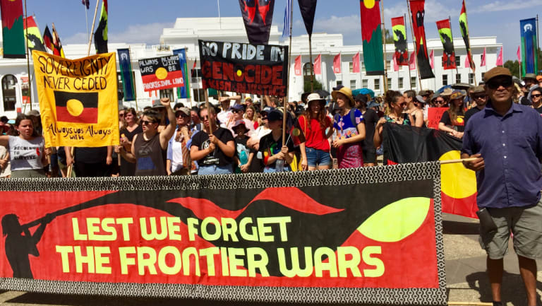 Invasion Day protesters arrive at the Aboriginal Tent Embassy opposite Old Parliament House on Saturday.
