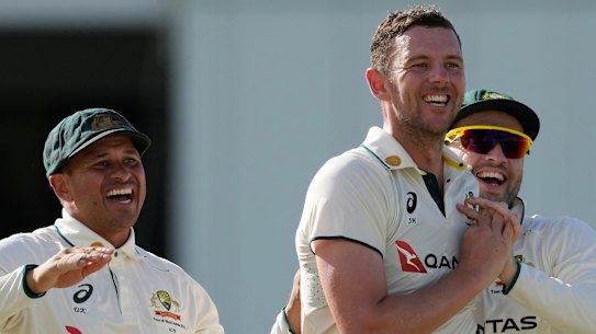 Australia’s Josh Hazlewood, centre, celebrates taking the wicket of West Indies’ Brandon King on day three of the first cricket Test match at Kensington Stadium.