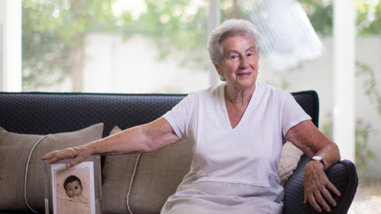 Holocaust survivor Nina Bassat, with a photograph of herself as a baby in 1939.