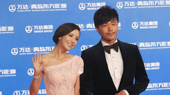 Actress Tong Liya and actor Chen Sicheng arrive at the red carpet during the opening night of the Qingdao Oriental Movie Metropolis at Qingdao Beer City on September 22, 2013 in Qingdao, China.  (Photo by Visual China Group via Getty Images/Visual China Group via Getty Images) .