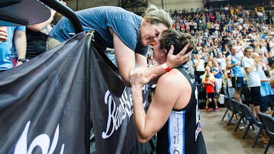Kelsey Griffin kisses her wife Erin after winning the grand final.