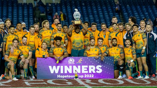 Australian players celebrate with the Hopetoun trophy after beating Scotland.