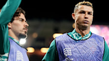 Cristiano Ronaldo (right) and Vitinha of Portugal warm up as substitutes.