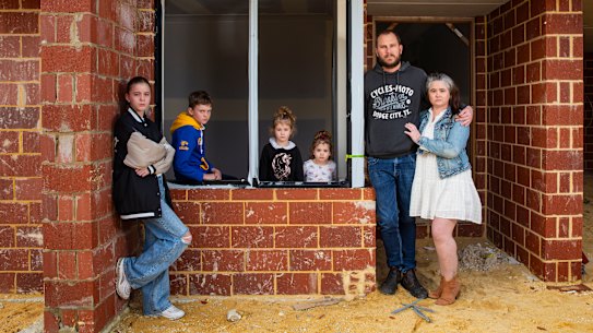 Zoe-Marie and Joel Masters with their children Temperance (12), Max (10), Grace (4) and Lilly (2) outside their unfinished home in Apsley, Perth.