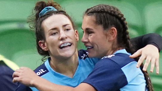 Maya Stewart is congratulated by Waratahs teammates after scoring a try at AAMI Park on Friday.