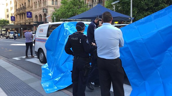 Police set up tarpaulins to shield the protesters from public view. 