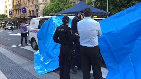 Police set up tarpaulins to shield the protesters from public view. 