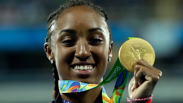 Gold medal winner Brianna Rollins from the United States shows off her medal during the medal ceremony for the women's 100-meter hurdles final during the athletics competitions of the 2016 Summer Olympics.