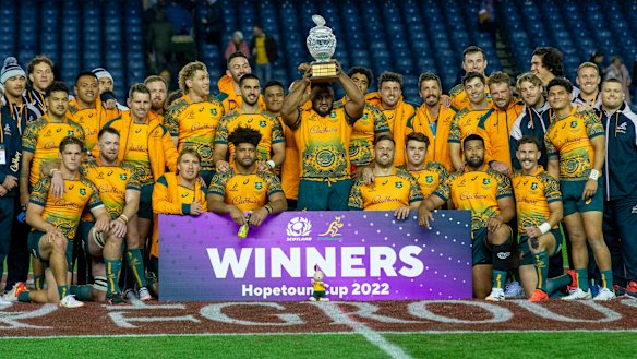 Australian players celebrate with the Hopetoun trophy after beating Scotland. 