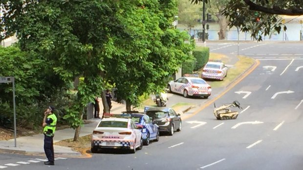 A police robot is deployed at a siege on Coronation Drive in Auchenflower.