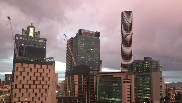 A strange orange glow enveloped the Brisbane CBD on Friday as dark clouds lingered.