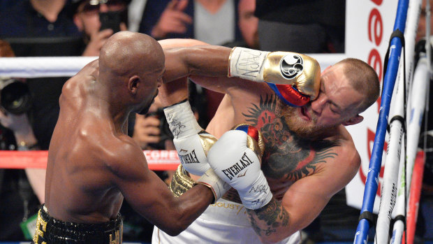 Pay day: Floyd Mayweather Jnr gets in the face of Conor McGregor. He won in a 10th-round stoppage in Las Vegas.