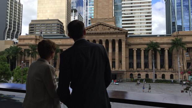 Outgoing Brisbane lord mayor Graham Quirk and his wife Anne look back at City Hall on the morning he announced he was stepping down from council.