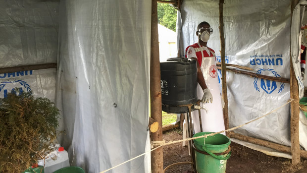 An Ebola screening checkpoint at the Bunagana crossing between Congo and Uganda. People crossing the border have their feet and hands washed with a chlorine solution. They also have have their temperature taken.