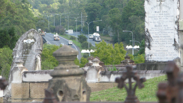 The graves of Toowong Cemetery look over the Western Motorway.