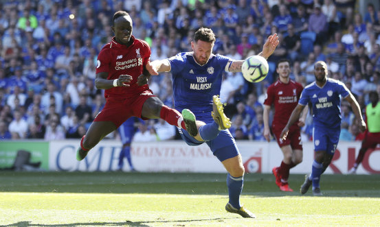 Liverpool's Sadio Mane and Cardiff City's Sean Morrison fight for the ball at Cardiff City Stadium on Sunday.