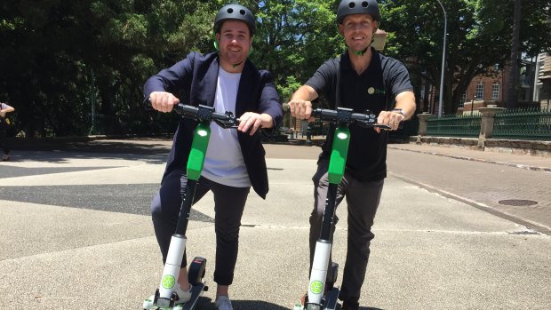 Lime's head of government relations Mitchell Price (left) and operations manager Ian Brouckaert with the Generation 3 scooter in Brisbane. 