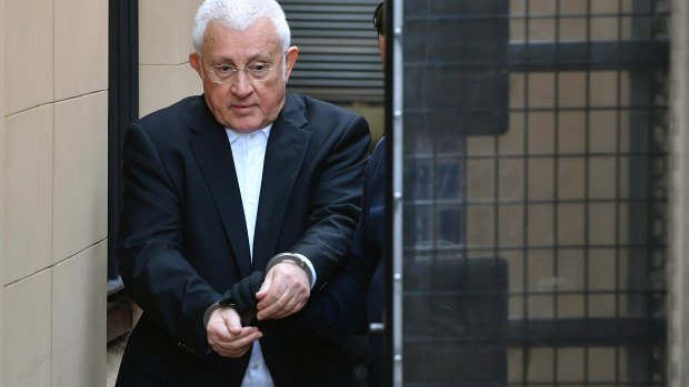 Ron Medich is escorted from court following his sentencing on Thursday. 