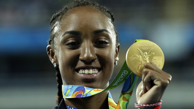 Gold medal winner Brianna Rollins from the United States shows off her medal during the medal ceremony for the women's 100-meter hurdles final during the athletics competitions of the 2016 Summer Olympics.