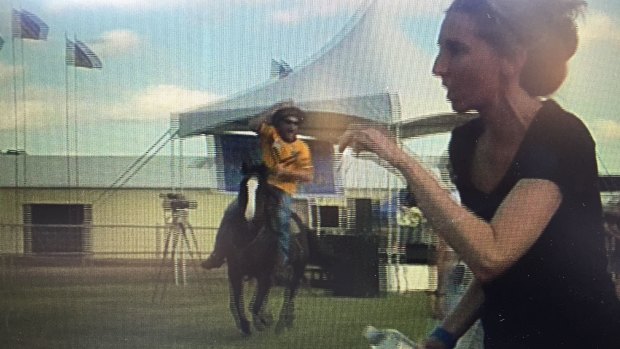 Video taken by an anti-Adani protester of a man riding a horse through Clermont showground.
