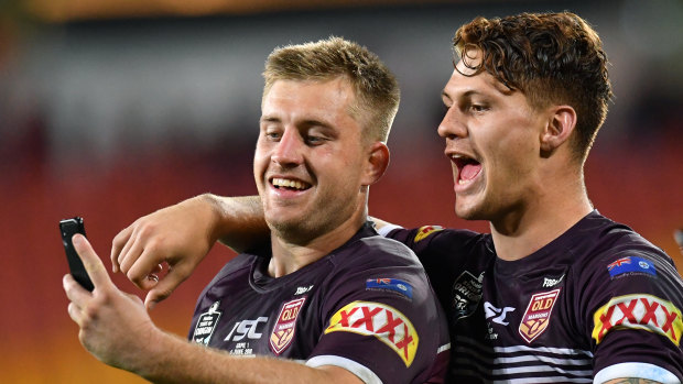 Pride of Queensland: Kalyn Ponga (right) and Cameron Munster take a happy snap at full-time.