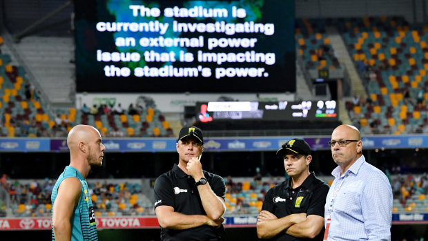 Dim view: Chris Lynn (left) of the Heat is seen talking to the match officials.