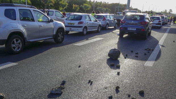 Stones left on the highway leading to the airport in Sainte Marie on Reunion Island as protesters, called the "yellow jackets", block the traffic.